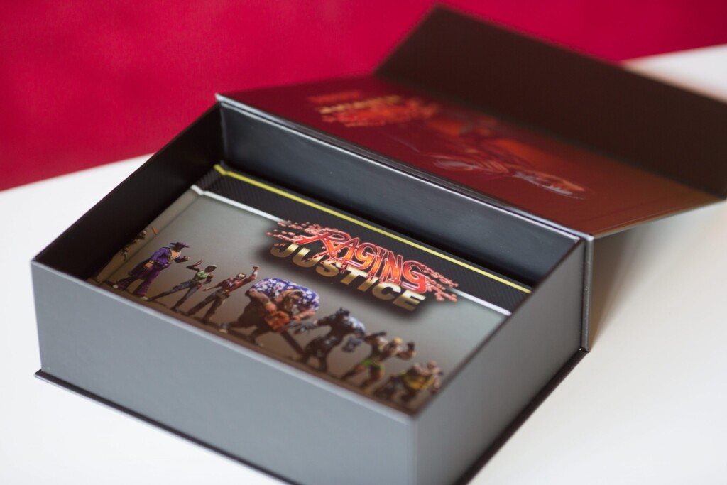 Open rigid box with slipcase containing Raging Justice collector's edition game with artwork insert and game case visible
