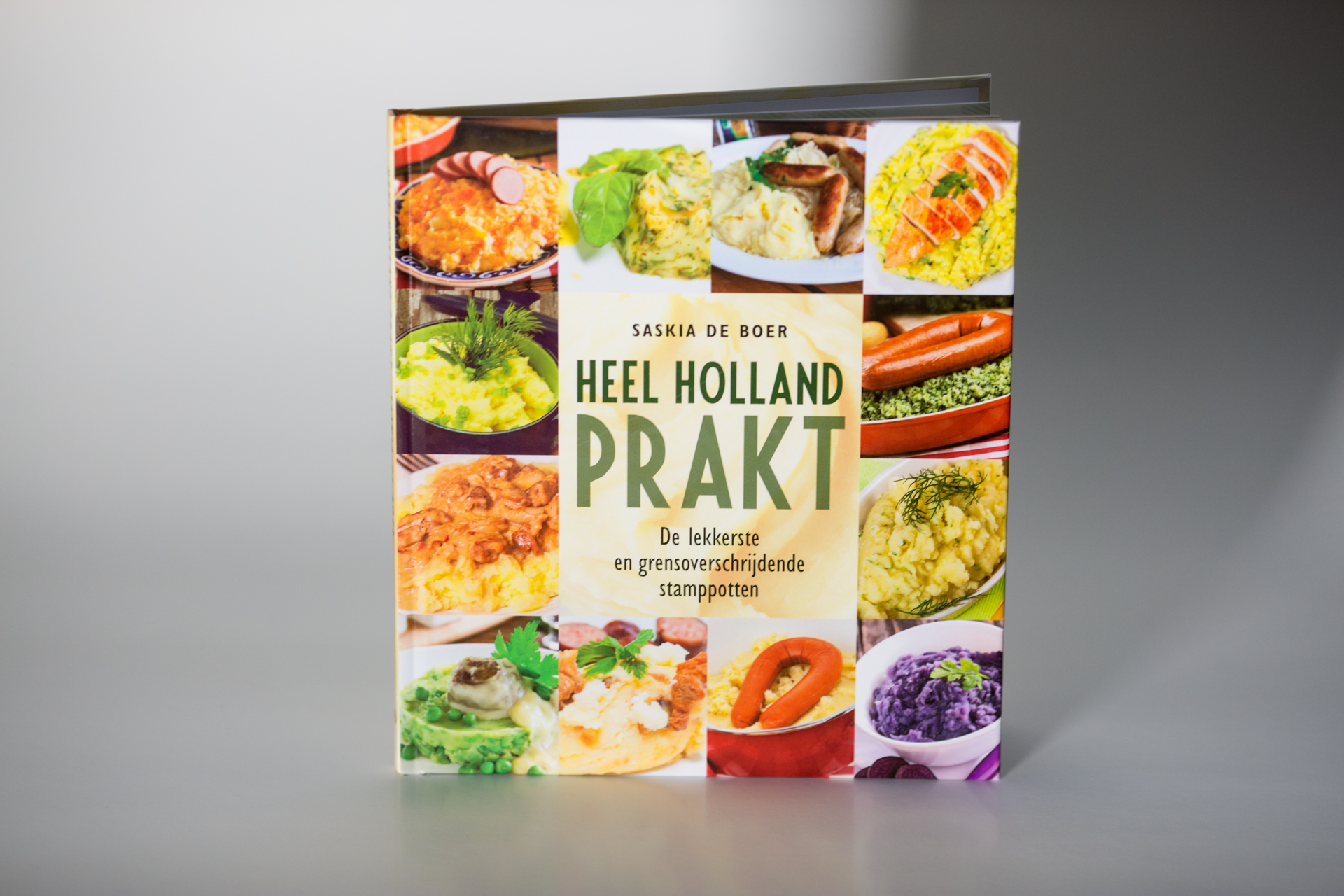 Hardcover cookbook titled Heel Holland Prakt by Saskia de Boer, featuring a collage of colourful Dutch dishes on the cover.