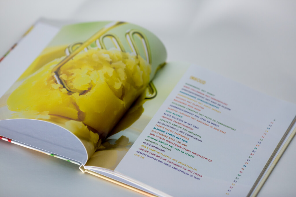 Open hardcover book with yellow corn cob image on left page and text on right page.