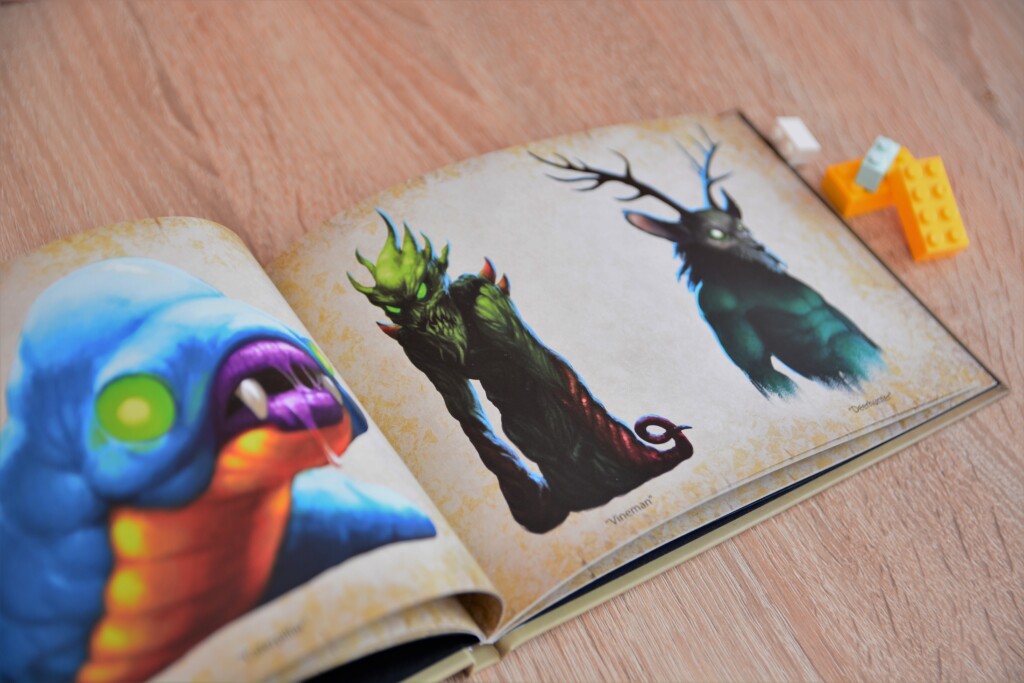 Hardcover artbook with open spread showing colourful bird illustrations and watercolour paintings on cream pages.
