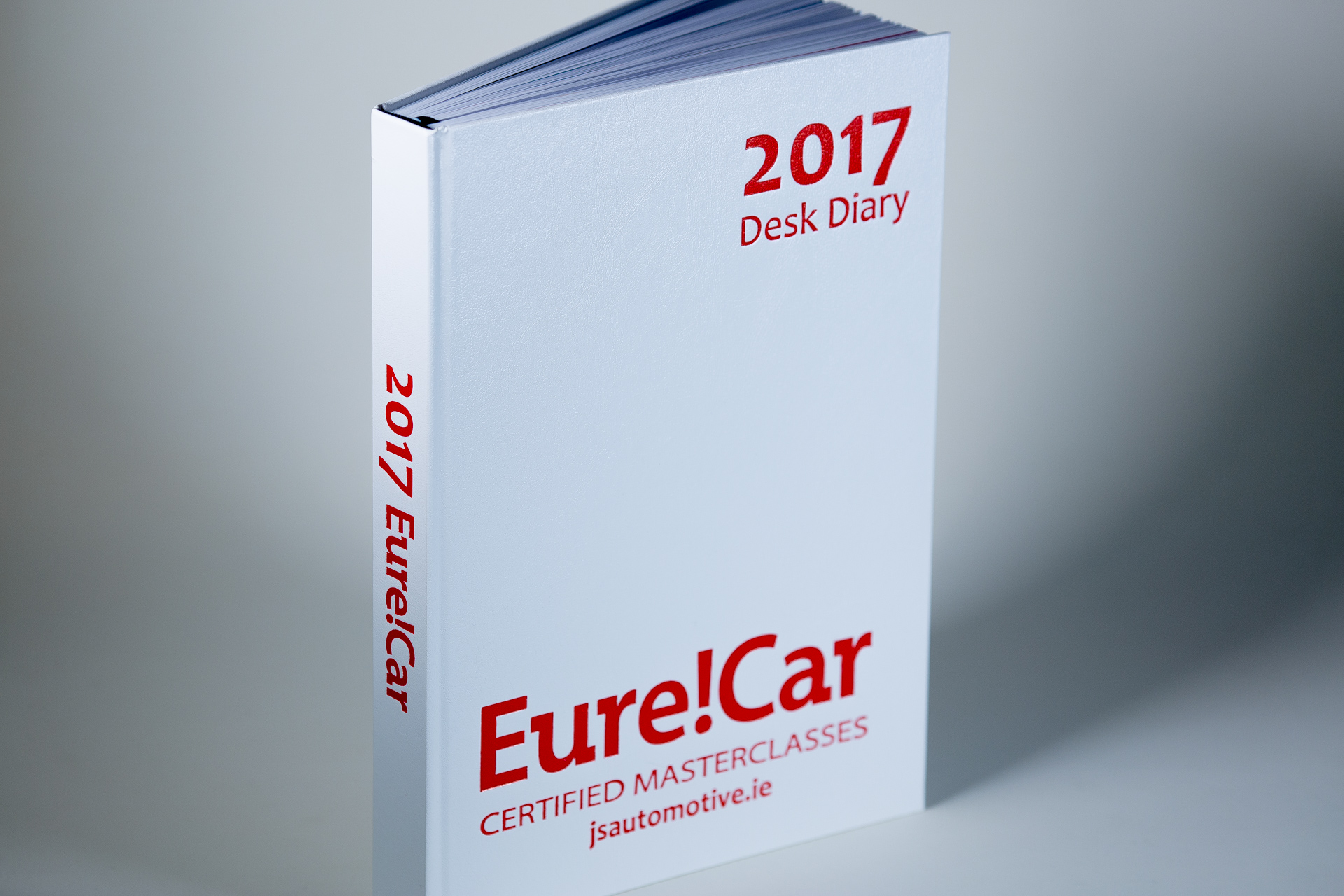 White hardcover book with "2017" and "EurelCar" printed in red on the spine and cover, displayed at an angle against a grey