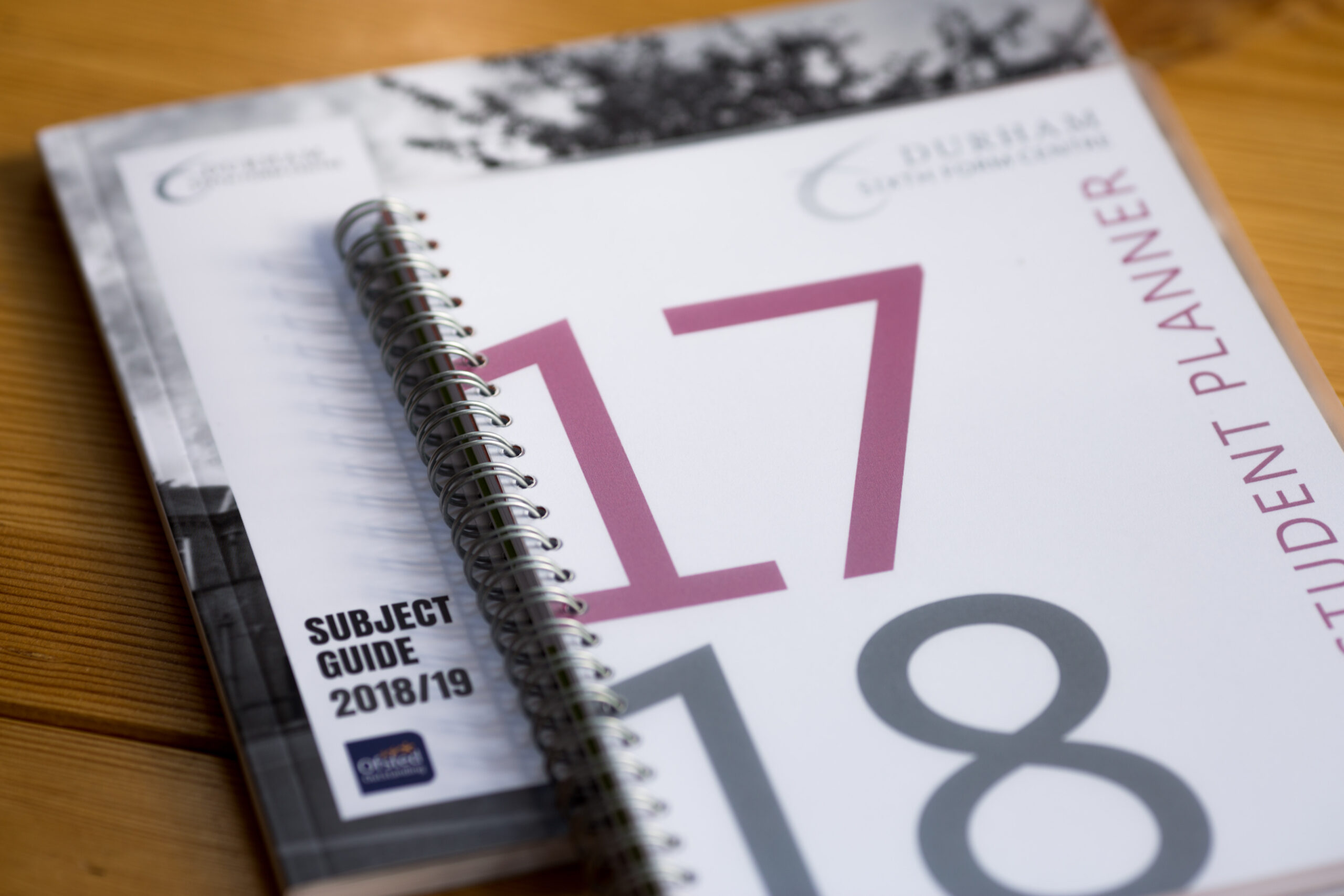Spiral-bound student planner with purple and grey numbers 17 and 8 on cover, alongside Subject Guide 2018/19 label, resting