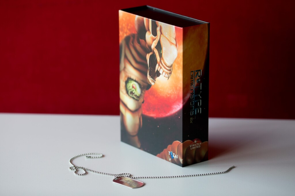 Hardcover book with black spine and illustrated cover featuring a person holding a glowing orb, displayed with a beaded