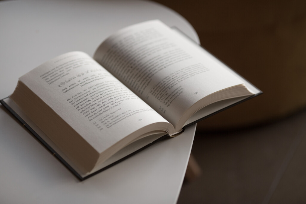 Hardcover book open to an interior spread with printed text pages visible.