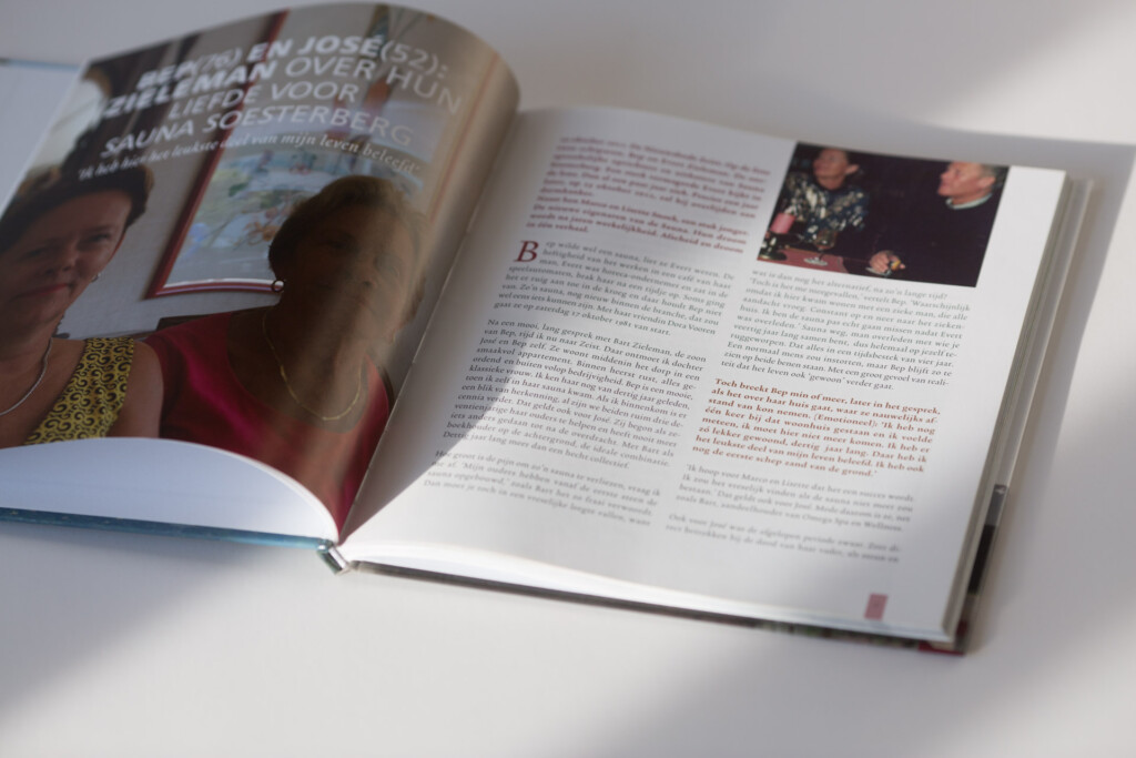 Hardcover book opened to a spread of Cyrillic text with a photograph, beside a closed copy showing a cover with overlaid
