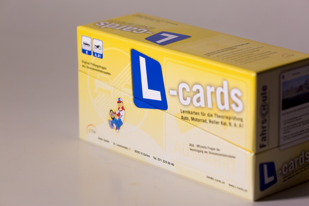 L-cards learning cards box with blue logo and yellow packaging, printed for driving licence examinations.