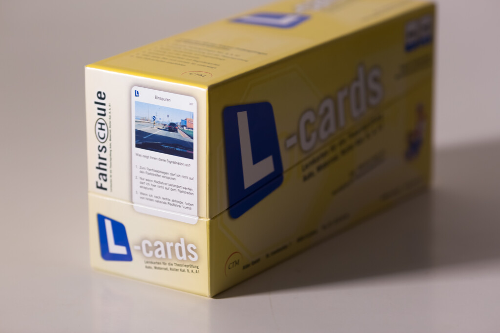 Yellow cardboard box for L-cards learning cards with product image and text visible on front panel.