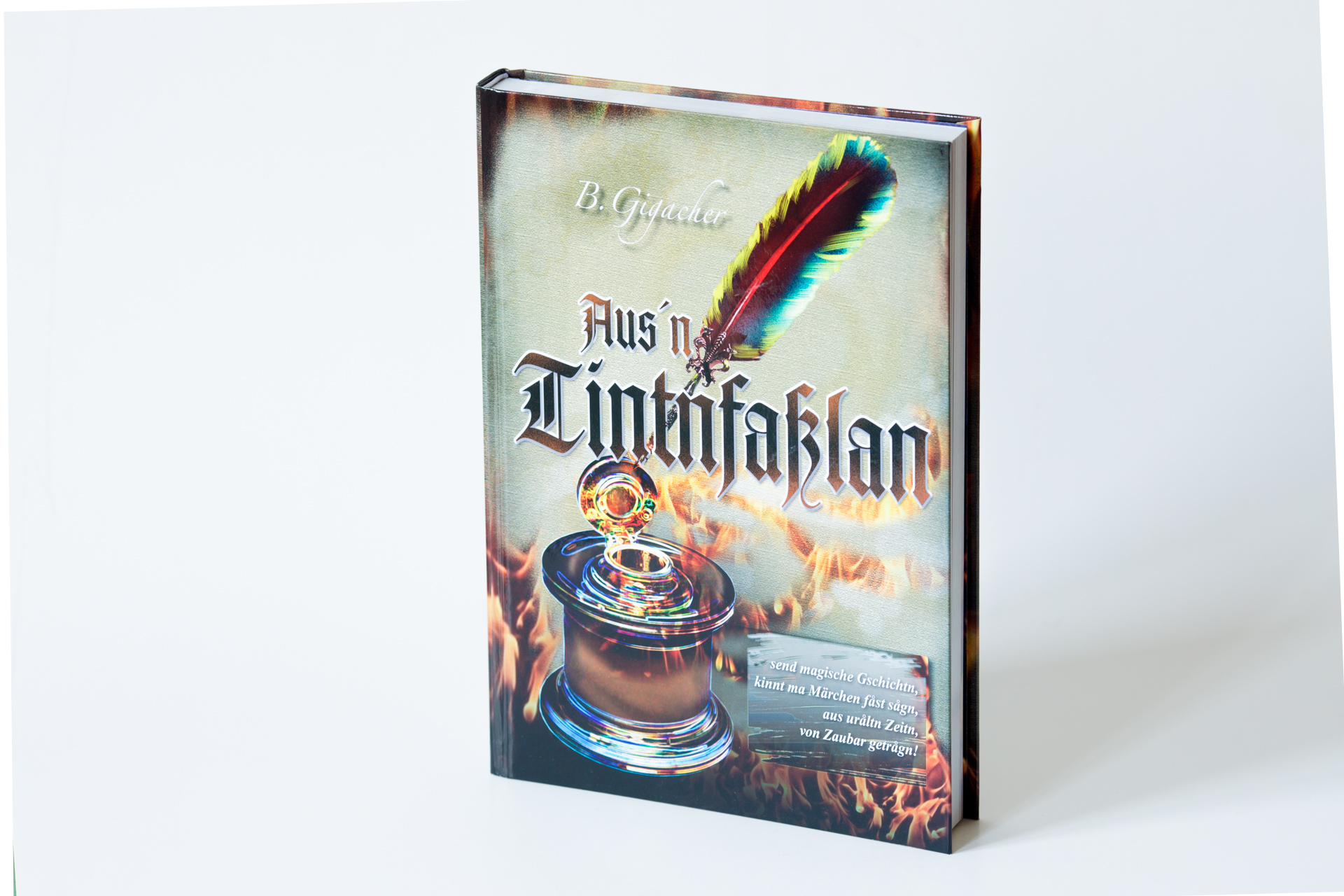 Hardcover book titled "Aus'n Tintfablan" with a colourful feather and decorative cauldron illustration on the cover.