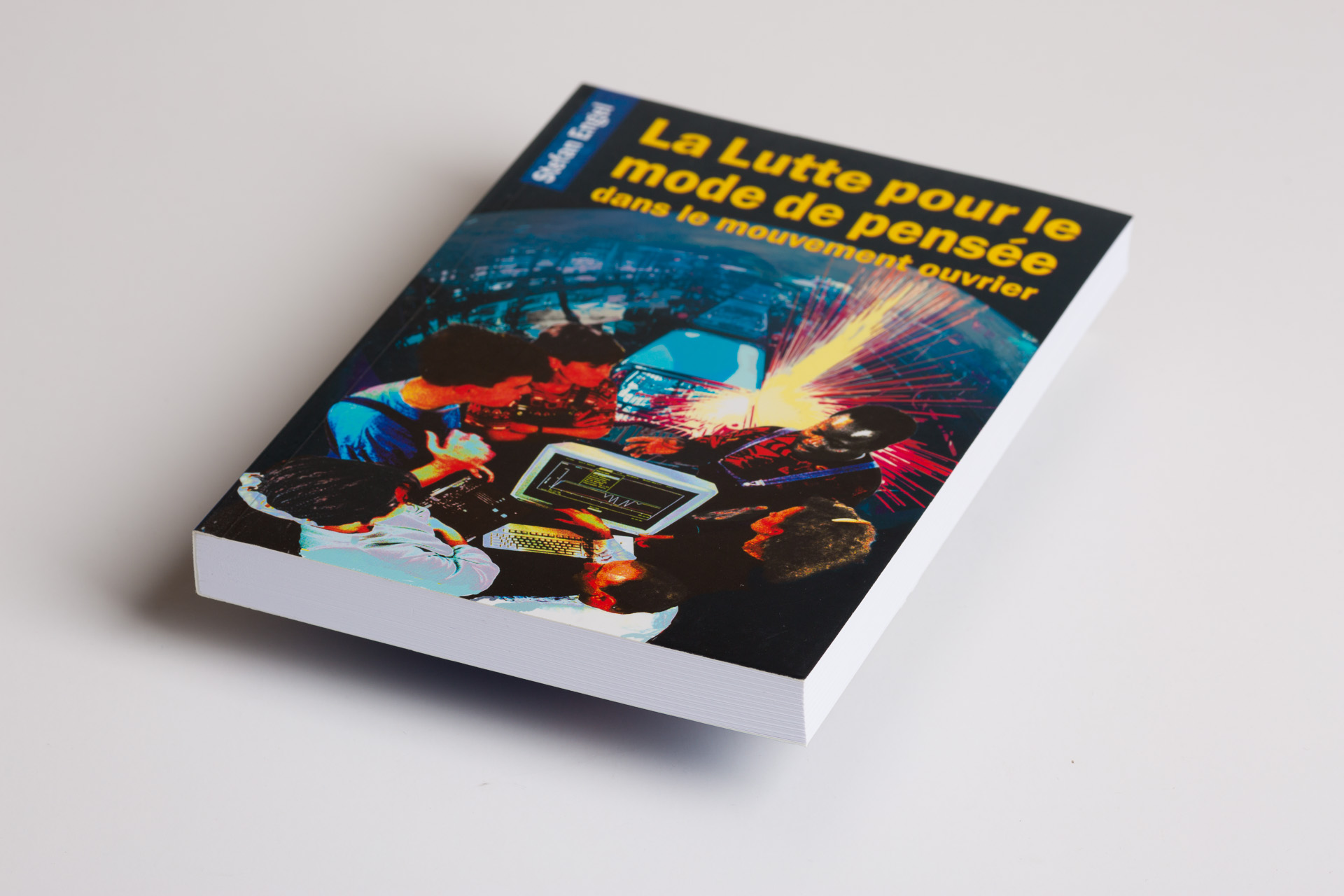 Softcover book with vibrant cover image showing colourful light effects and technology elements, title in French and yellow