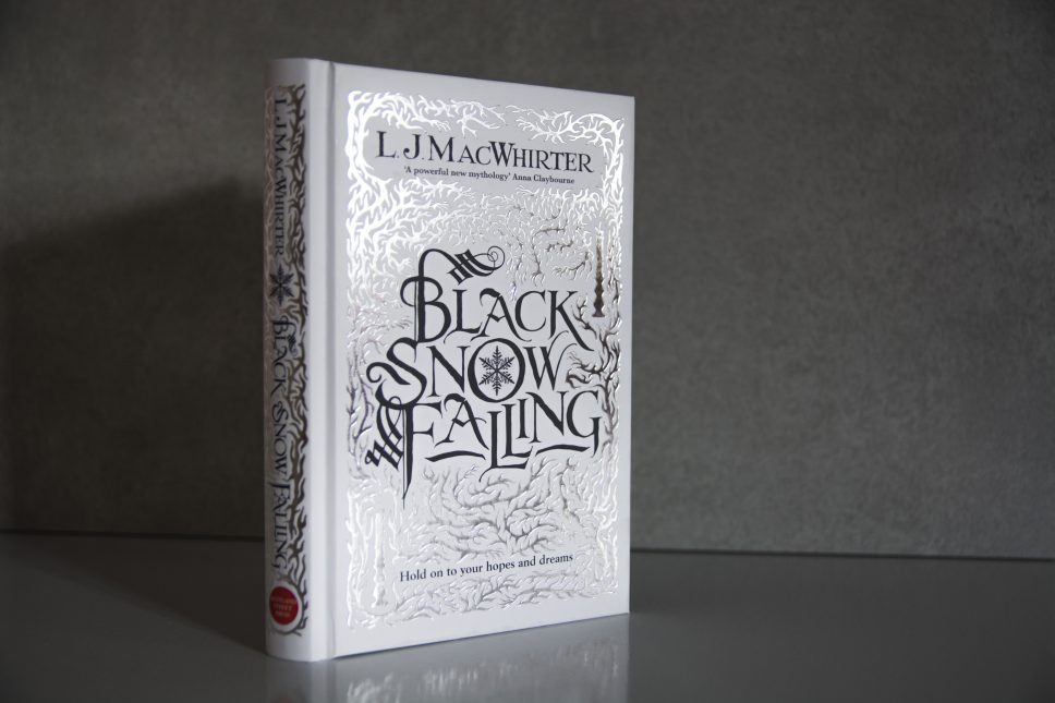 Black Snow Falling by L.J MacWhirter, hardcover novel with silver foil stamping on white cloth cover.