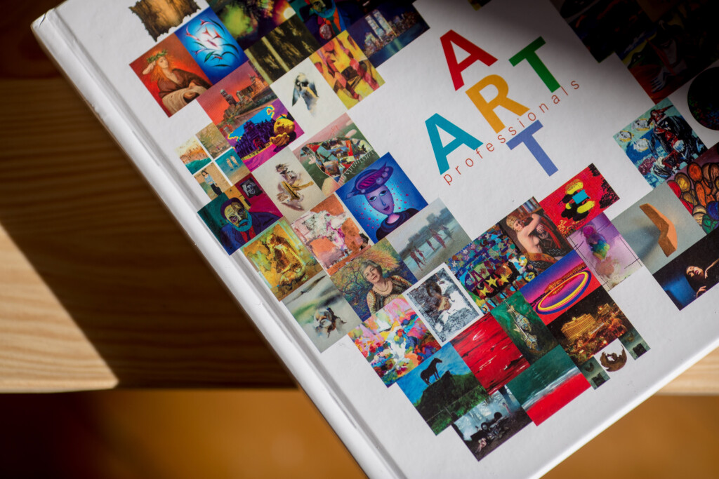 Art book with hardcover binding, white cover featuring colourful image collage and "ART" text in multicoloured letters.