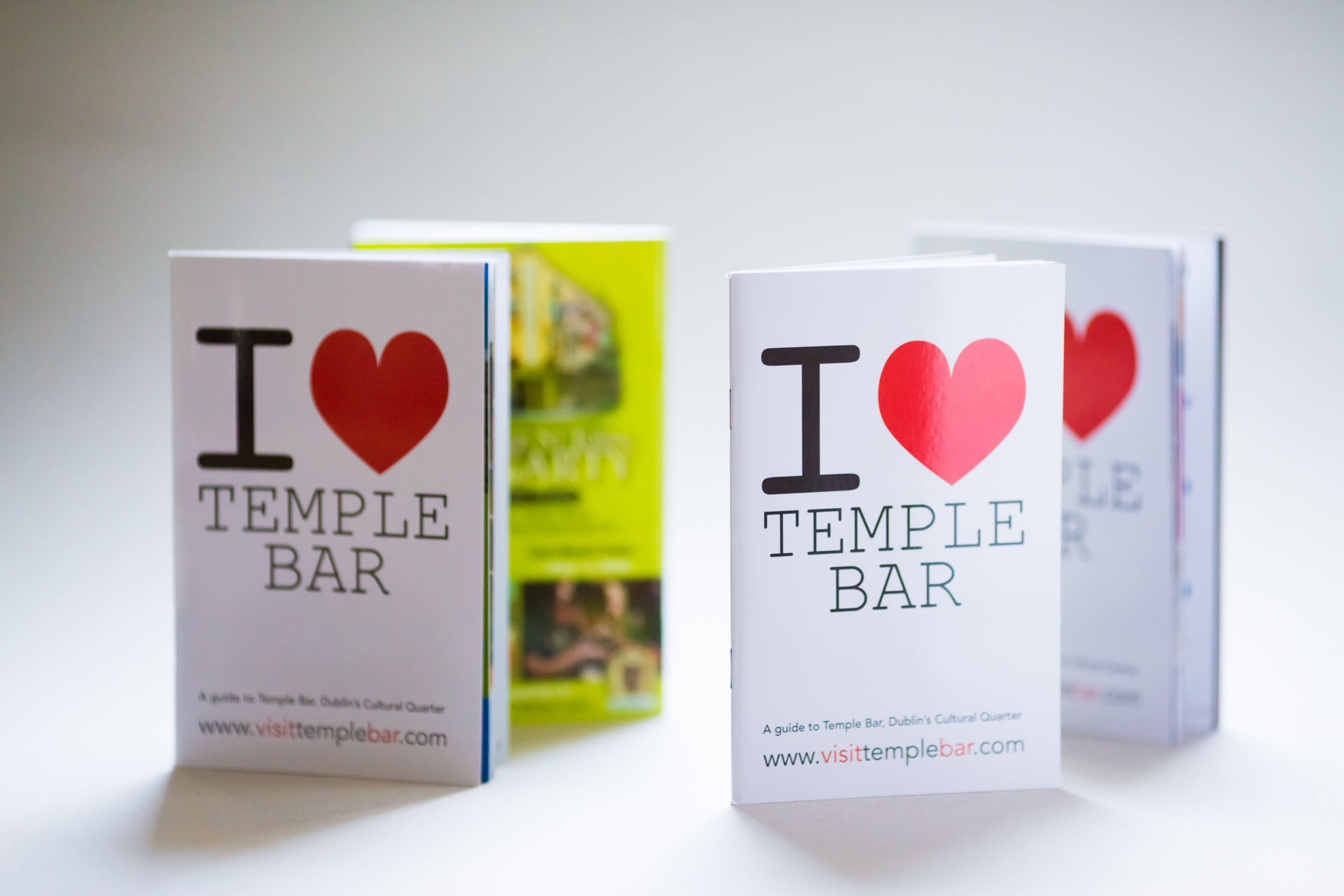 Two softcover guides to Temple Bar with "I ♥ Temple Bar" covers in different colour schemes, fanned open to show interior