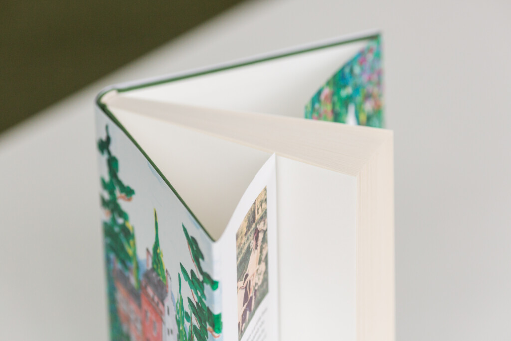 Hardcover book with illustrated dust jacket, open to show binding and interior pages with text and imagery.
