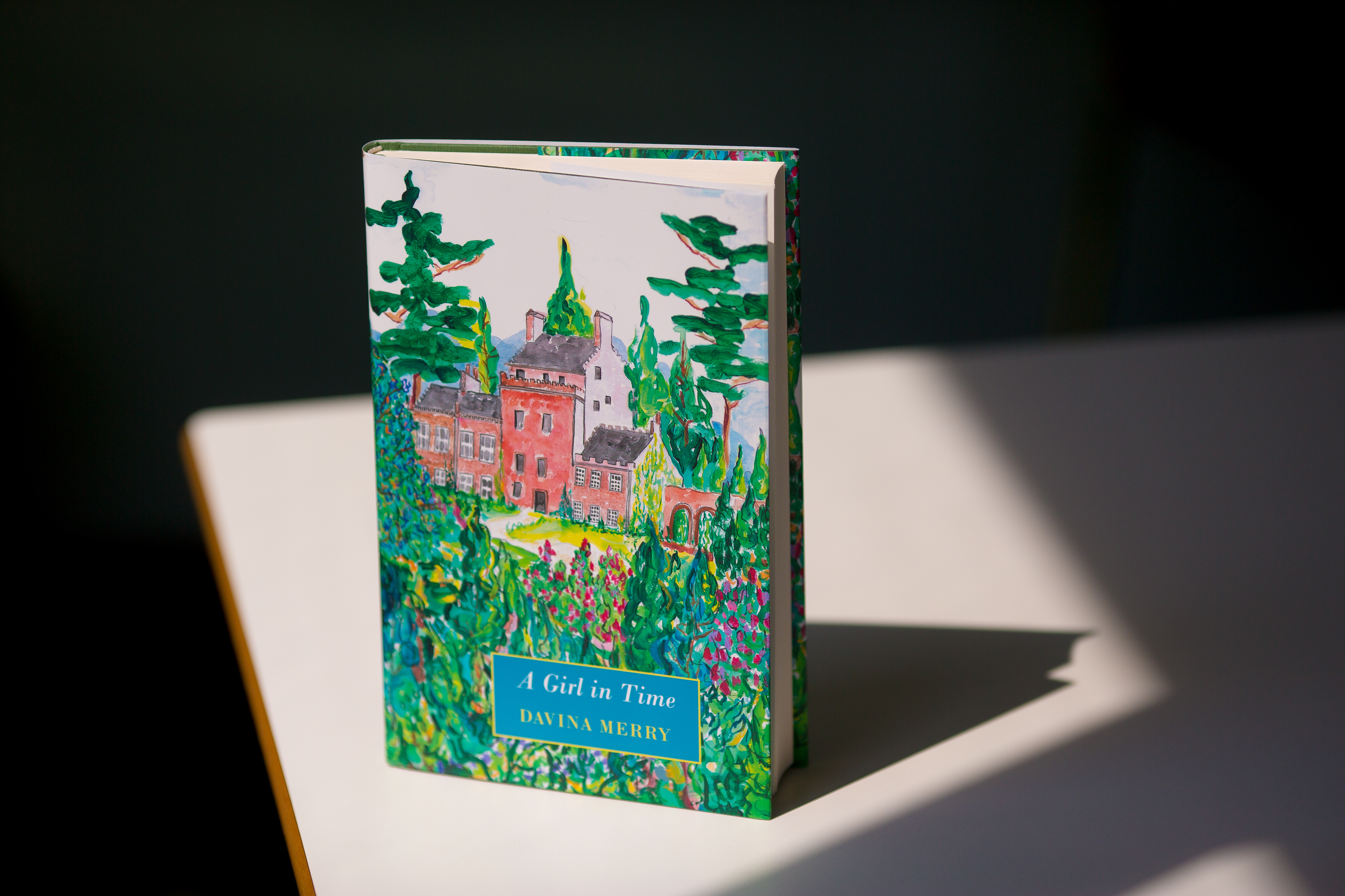 A Girl in Time hardcover book with illustrated dust jacket showing a red castle surrounded by green trees and foliage.