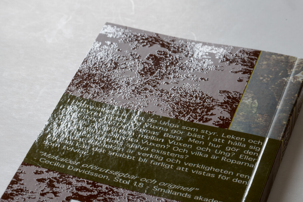 Hardcover book with embossed and foil-stamped cover featuring abstract brown and white textured design and green text panel