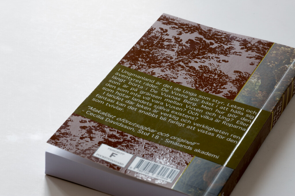Hardcover book with brown textured cover and green panel featuring text on the back, barcode visible on lower edge.