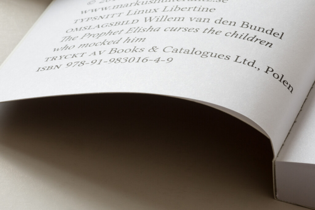 Open book showing copyright page with publisher details and ISBN, demonstrating sewn binding and text layout.
