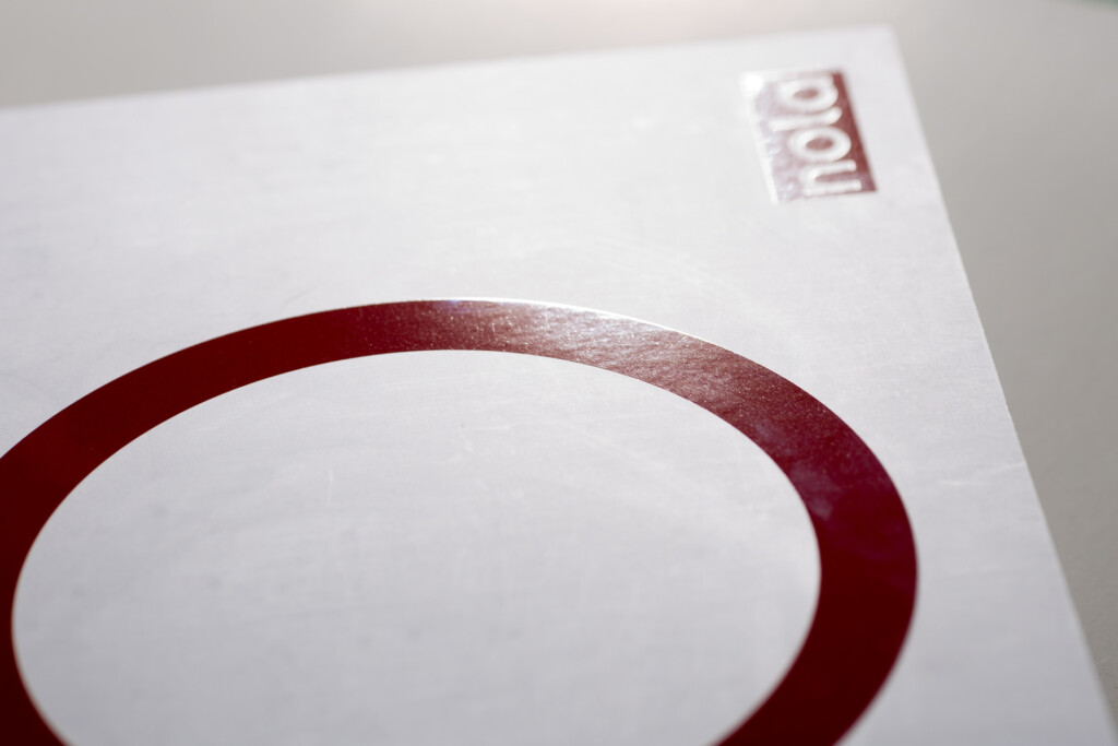 Printed catalogue with burgundy oval border detail on white cover and postage stamp in upper right corner.