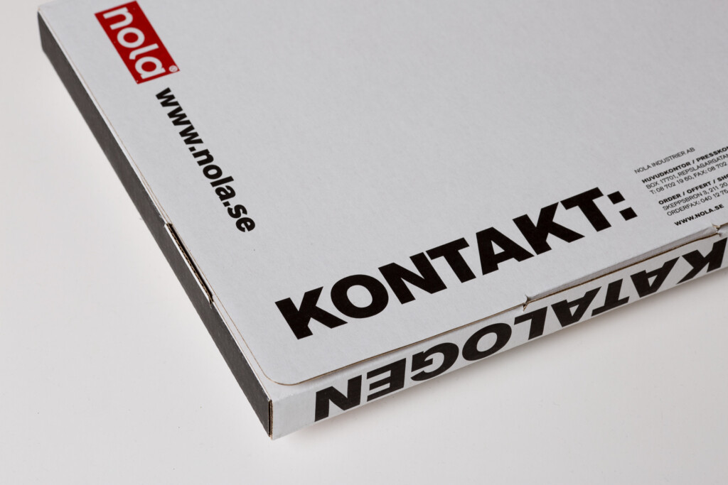 White softcover catalogue with red "bold" logo and "KONTAKT:" text visible on cover, displayed at an angle.