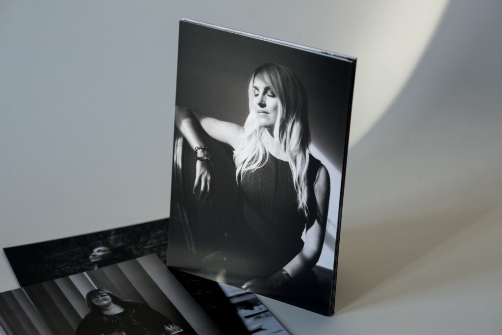 Printed calendar displayed open showing black and white portrait photograph on front cover with stack of calendar pages