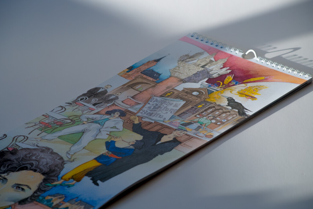 Wall calendar with colour illustrations fanned out, showing interior pages with artwork and text.