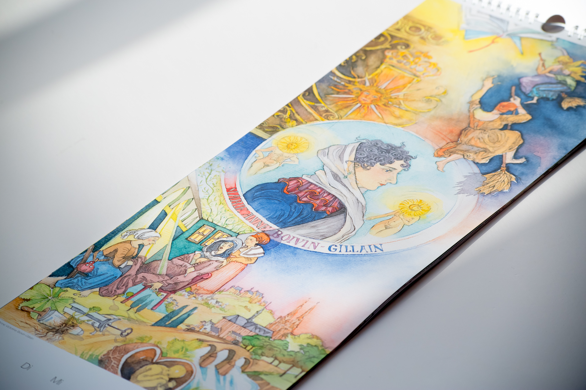 Wall calendar with illustrated scenes of British landmarks and culture, including Big Ben and a portrait medallion.