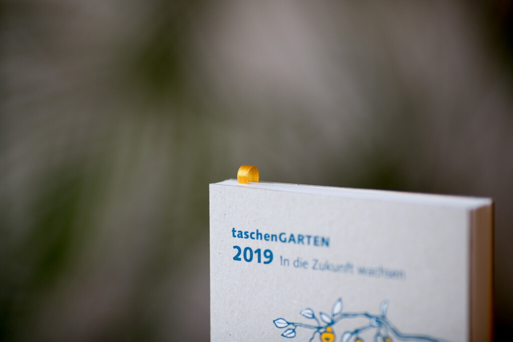 Taschen Garten 2019 catalogue with hardcover binding and gold foil-stamped cover detail, displayed at an angle.