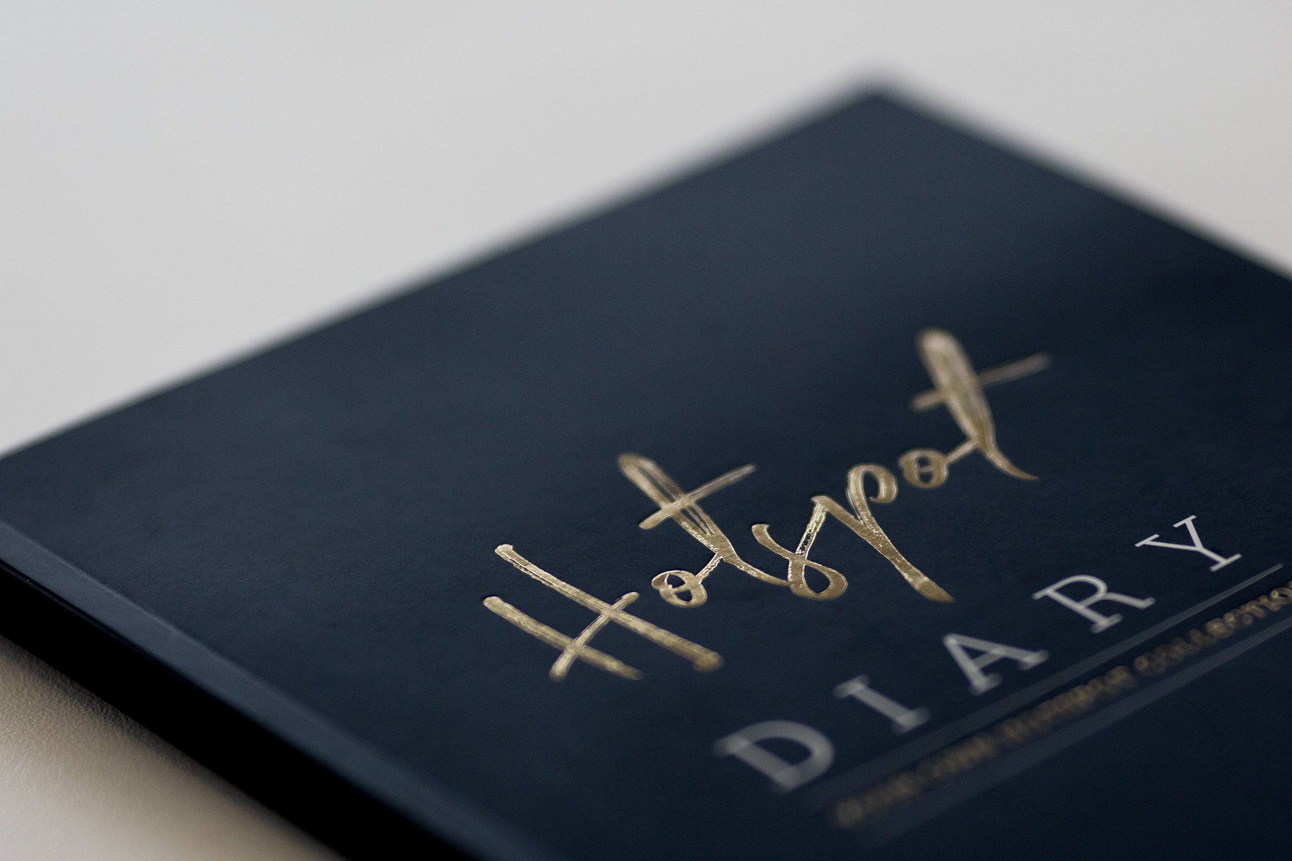 Dark blue hardcover diary with gold foil-stamped lettering on the cover.