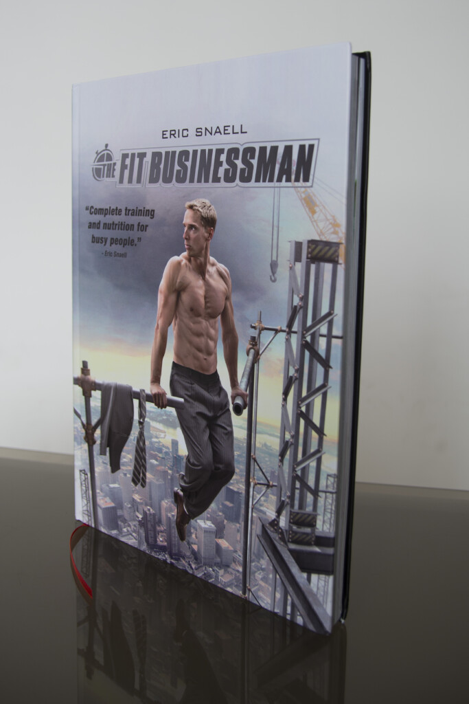 Hardcover book with dust jacket featuring a shirtless man holding a rifle, standing against an industrial background